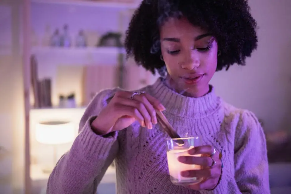 Young woman in jumped lights a candle