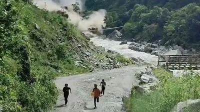 Men run from valley as water crashes down behind them