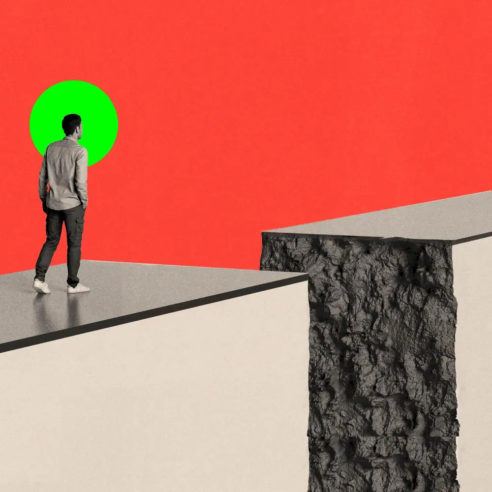 A person standing on a path which is crumbling