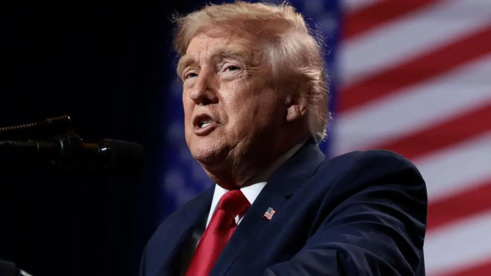 U.S. President Donald Trump delivers remarks at Red Rock Casino Resort Spa in Las Vegas, Nevada, U.S., August 5, 2026. It is a head-and-shoulders shot and he is wearing a blue jacket and shiny red…