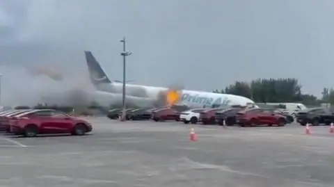 Prime Air plane nose down after crashing at Miami airport.