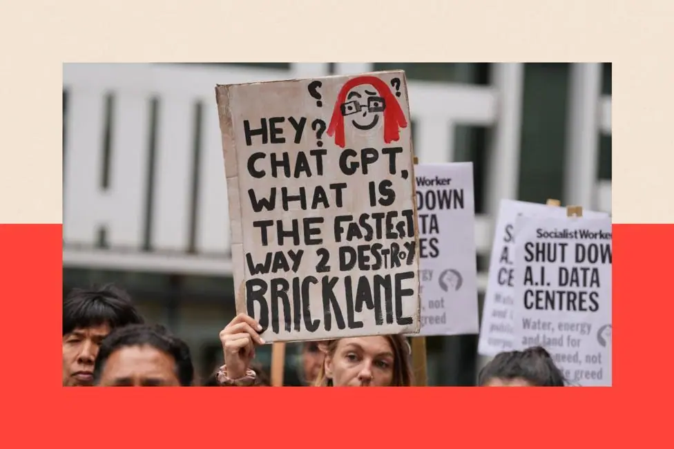 People holding placards against the approval of a data centre in the government's redevelopment plans for Brick Lane which reads: "Hey ChatGPT, what is the fastest way 2 destroy Brick Lane"