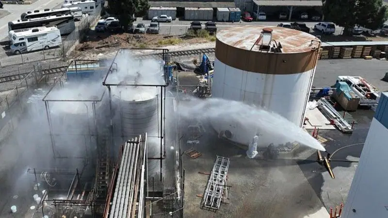Water is sprayed on the overheating tank in Los Angeles in May.