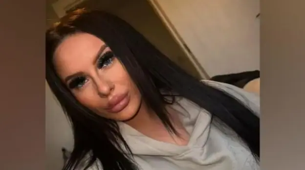 Selfie of Emma Ashfield, a young woman with long, dark hair, weaing a grey hooded sweatshirt