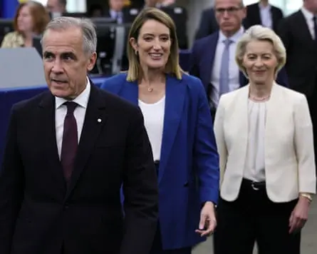 Mark Carney, Roberta Metsola and Ursula von der Leyen walk through the European parliament building