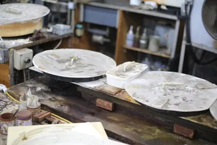 A workbench with vinyl moulds on it