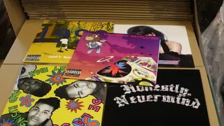 A selection of LP sleeves laid out on top of a box in the factory