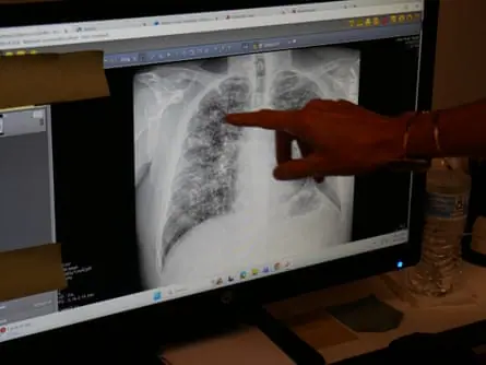a person pointing to a screen