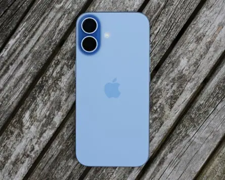 An iPhone on a wooden table outside