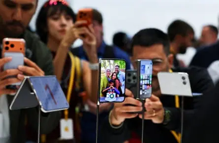 Apple holds event at the Steve Jobs Theater on its campus in CupertinoPeople look at the new foldable iPhone Duo devices on display during Apple’s event at the Steve Jobs Theater in Cupertino…