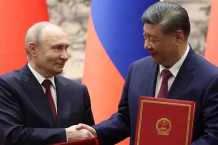 Vladimir Putin shakes the hand of Xi Jinping in Beijing, 20 May 2026.