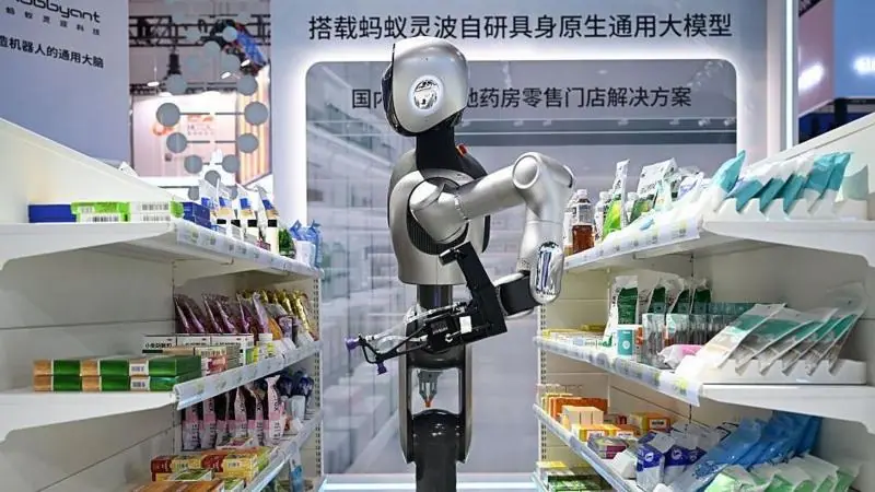 A pharmacy robot organises packs of medicines in a mock-up shop.
