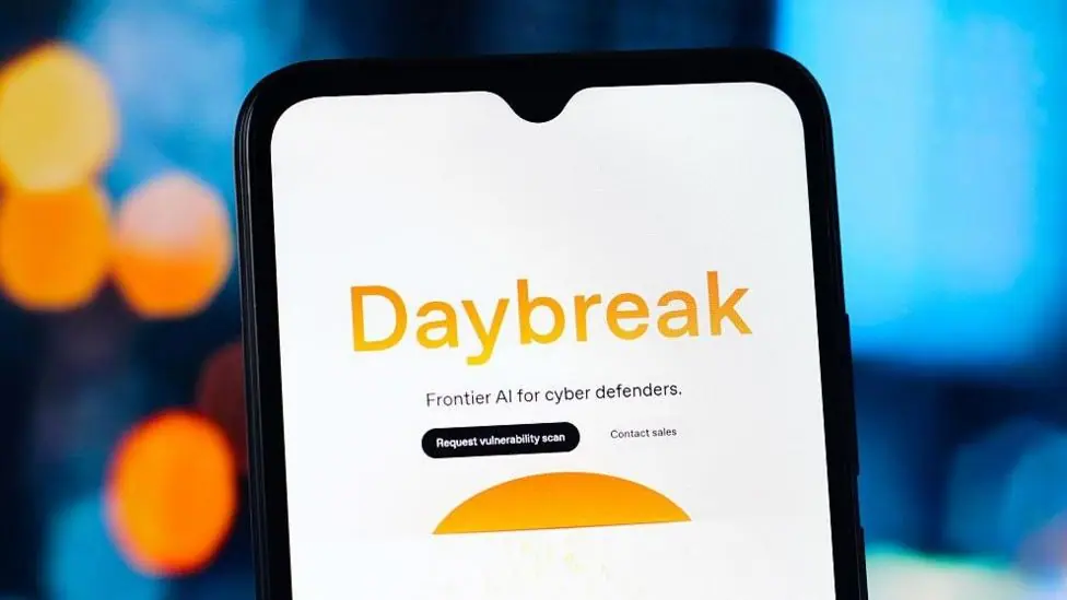 The word Daybreak in orange against a white phone background. Below it says Frontier AI for cyber defenders.