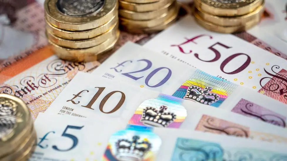 Pound coins and a 5,10,20 and 50 pound note