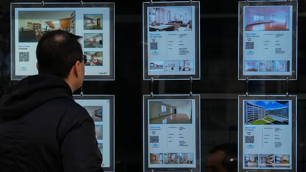 File - A man looks in the window of an estate agency with properties mainly for sale in Madrid, Spain, Tuesday, 18 April 2023.