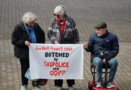 Supporters of Susan Neill-Fraser hold up a banner saying her case was botched