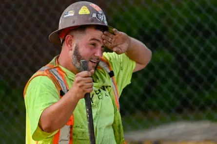 A man wiping sweat off of his brow.