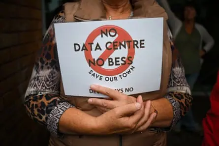 A person at a demonstration holding a sign that reads ‘No datacentre, no BESS’