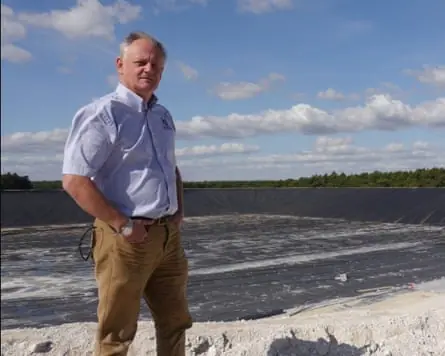 Andrew Blenkiron, managing director of the Elveden estate in Suffolk, next to a new reservoir called Summerpit.
