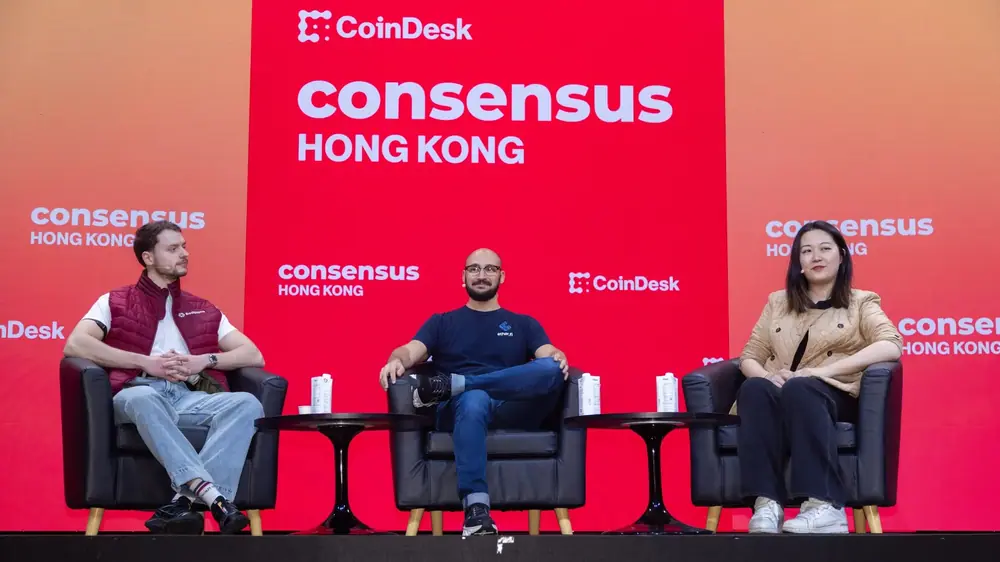 Three people, including Ether.fi CEO Mike Silagadze, sit on a stage at Consensus Hong Kong 2025.