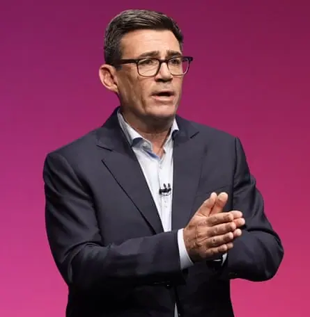Andy Burnham in shirt and jacket gives speech at Labour conference
