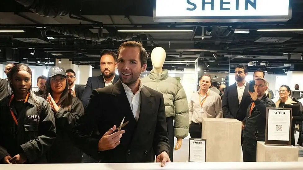 The director of the Bazar de l'Hotel de Ville (BHV) department store Karl-Stephane Cottendin prepares to cut the ribbon at the opening of Asian e-commerce giant Shein's first physical store at the…