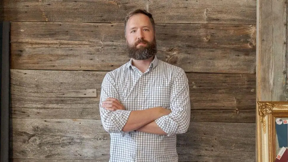 Scott Duncan looks at the camera with his arms crossed