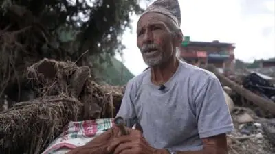 Man sitting in the wreckage of the flood.