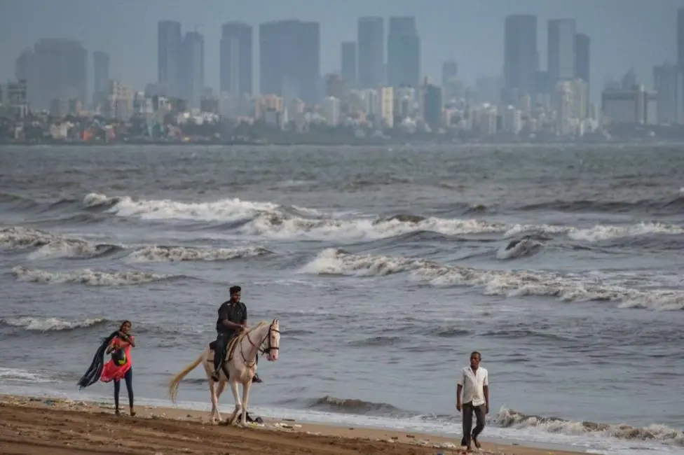 A man rides a horse at Versova Beach in Mumbai.