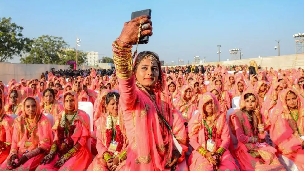 A Muslim bride takes a selfie with her mobile phone as she participates in an 'All Religion Mass Wedding' ceremony at Sabarmati Riverfront in Ahmedabad