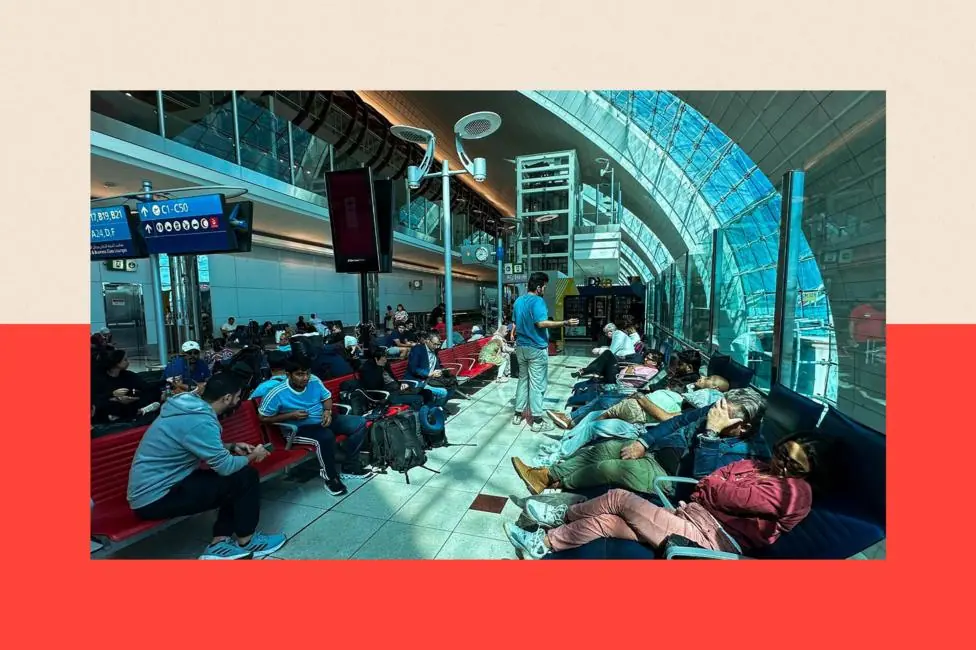 An airport terminal full of people waiting