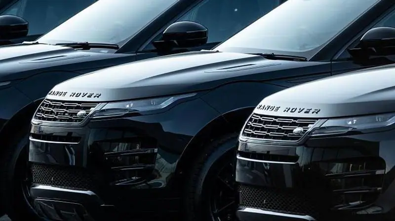 A row of black Land Rover cars