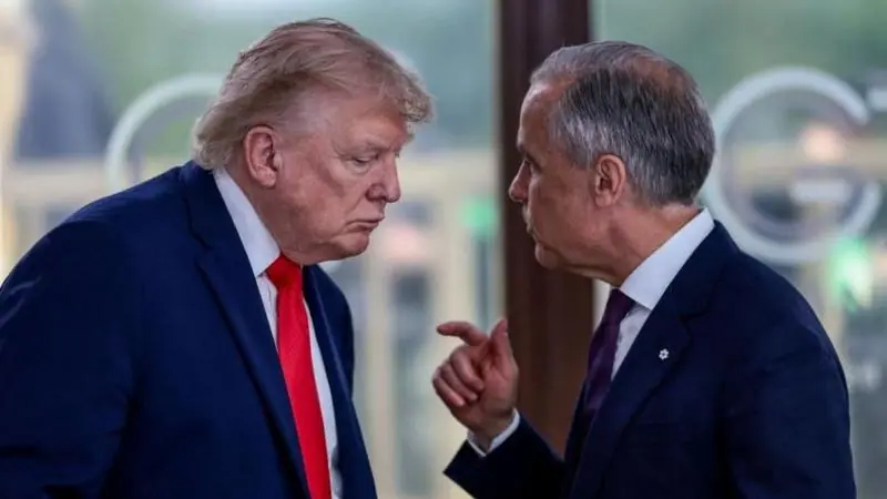 A file image showing U.S. President Donald Trump at a working lunch with Prime Minister Mark Carney and other G7 leaders. The image shows Carney and Trump side by side mid-conversation. Both are…
