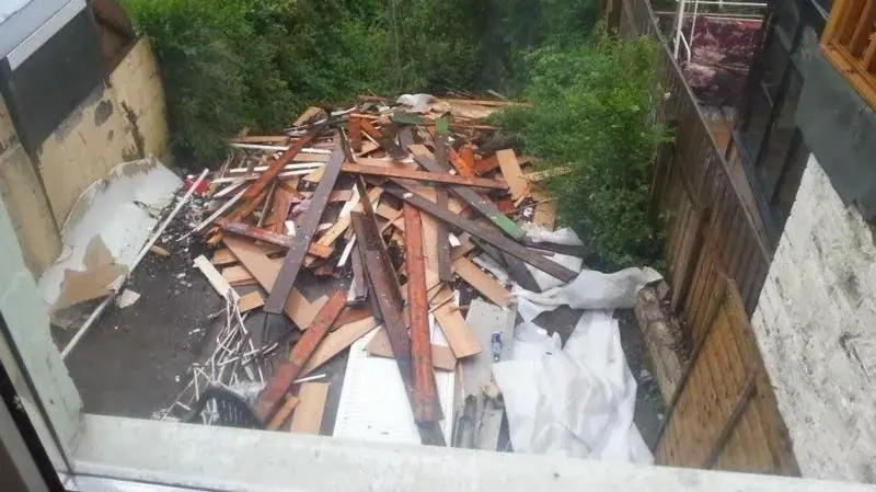 Piles of wood panels and other household materials removed from the home during building work. The waste was left by Lee Slocombe outside the home, following incomplete renovation work.