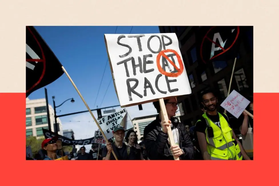 A person marches at an anti-AI protest with a sign that reads "Stop the AI race"