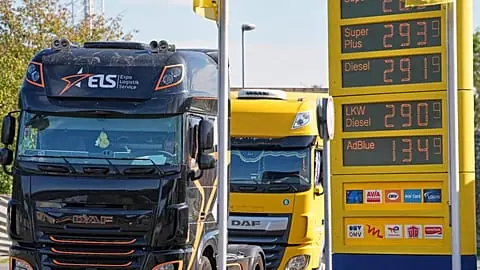 A fuel station shows record fuel prices beside trucks on a highway in Herten, Germany, one day before the German government starts a fuel tax discount, Wednesday, Sept. 30, 20