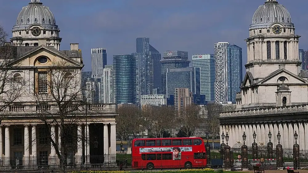 FILE - The Old Royal Naval College in Greenwich frames buildings in London's financial area Canary Wharf, in London, Thursday, 27 March 2025.
