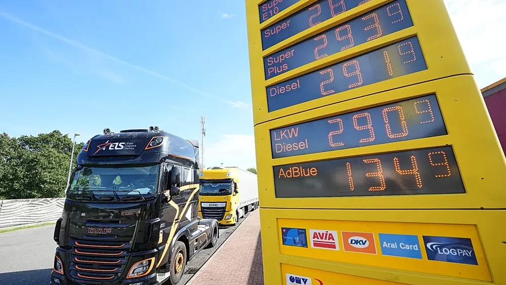 A fuel station shows record fuel prices beside trucks on a highway in Herten, Germany, one day before the German government starts a fuel tax discount, Sept. 30, 2026