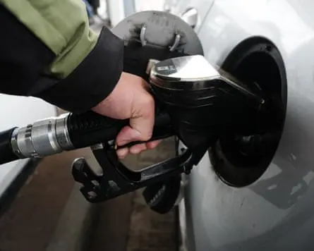 A close-up of someone filling up their car at a petrol station in the UK