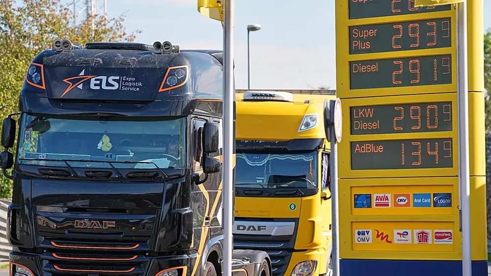 A fuel station shows record fuel prices beside trucks on a highway in Herten, Germany, one day before the German government starts a fuel tax discount, Wednesday, Sept. 30, 20
