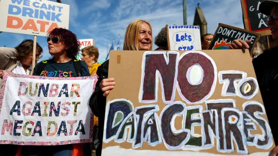 A number of people protesting outside the Scottish Parliament about data centres. Many of them are holding signs