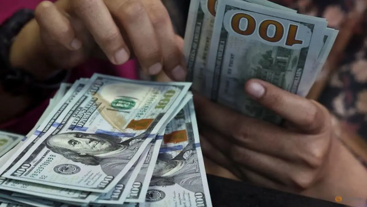 Dollar holds losses as markets await Fed minutes, speakers