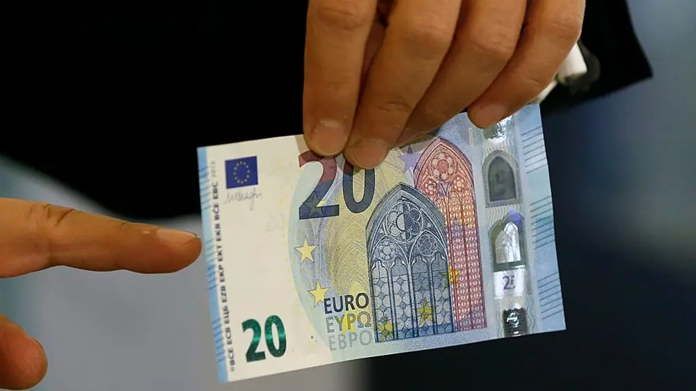 File - Yannis Stournaras governor of Bank of Greece shows the new 20 euro note in Athens, Tuesday, 24 November 2015.