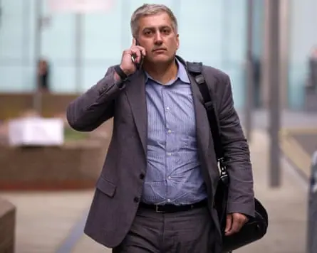 Jay Merchant on the phone as he leaves Southwark crown court in London during his trial in 2016.