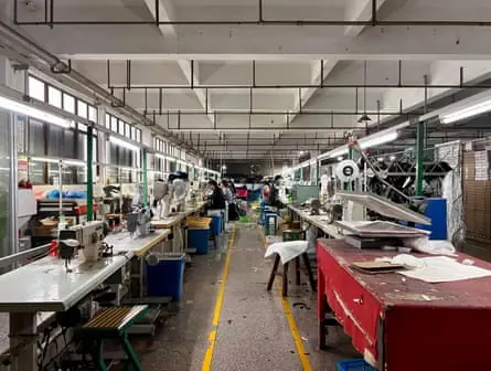 Desks and machinery line the inside of a shoe factory