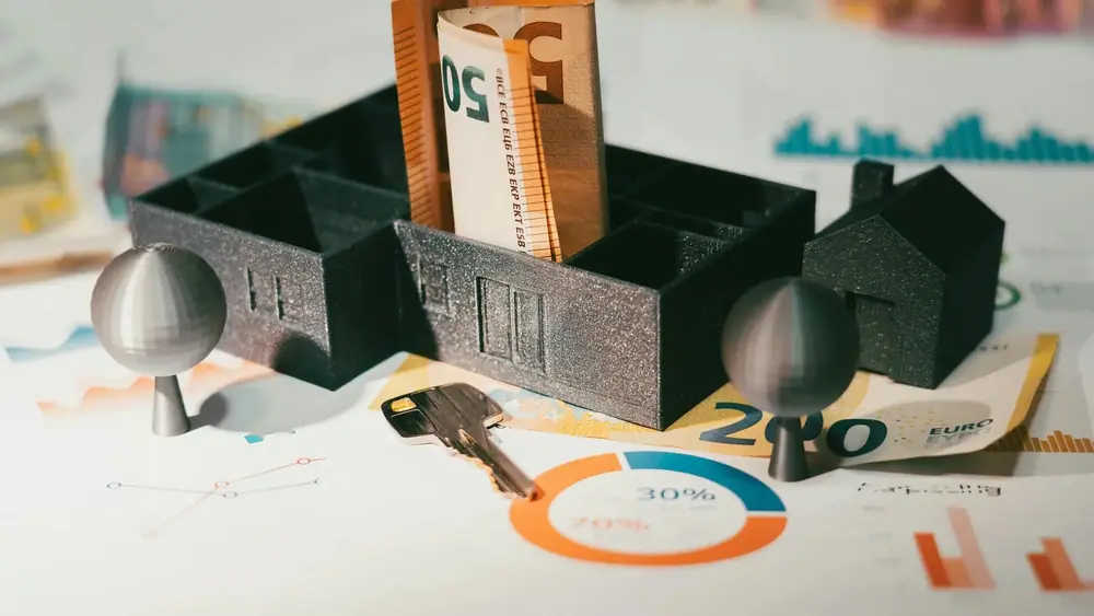 A 50-euro note inside a model house. (Jakub Żerdzicki/Unsplash)