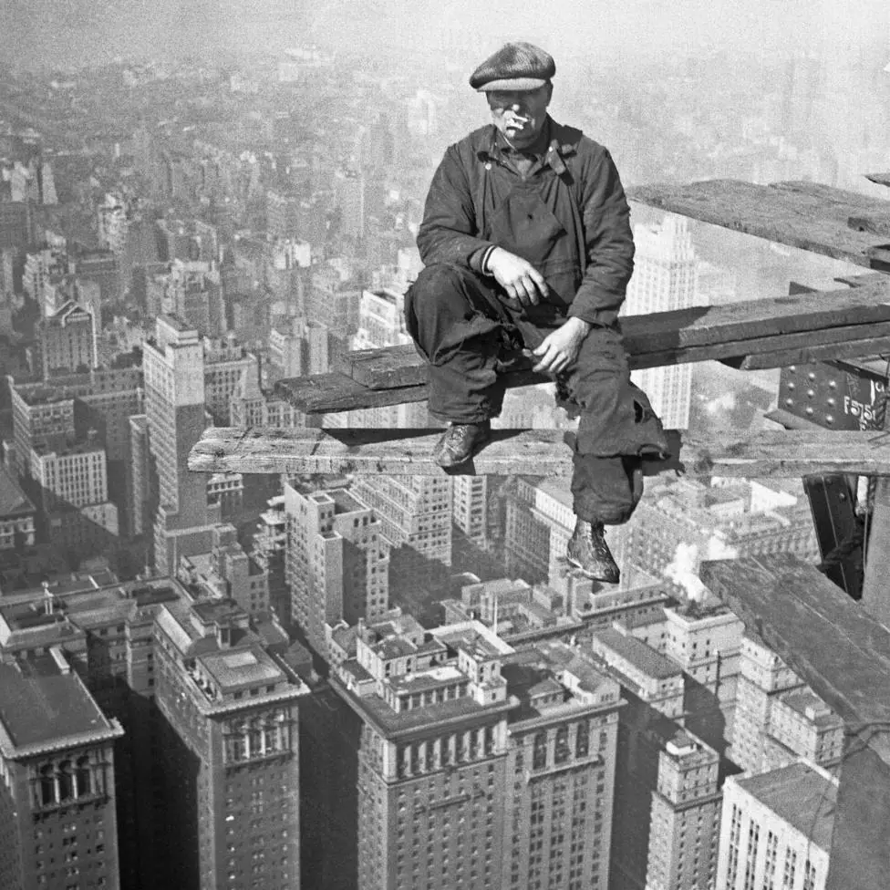 A man eats a sandwich hundreds of feet up during the construction of the Chrysler Building