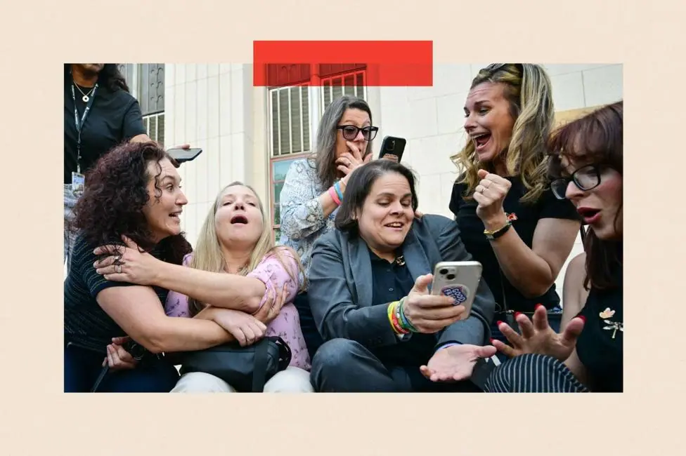 Laura Marquez-Garrett (3R, gray blazer), plaintiffs' attorney for SMVLC (Social Media Victims Law Center), gathers with family members of victims as they react to news that the jury has found Meta…
