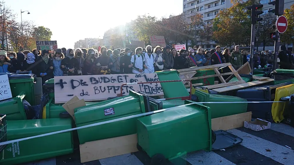 Students stand in front of the blockaded Helene Boucher high School as they protest against under-resourced schools, in Paris, Thursday Oct. 8, 2026.