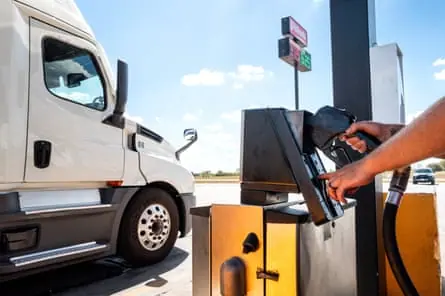 A person filling up at a gas station in Buda, Texas.